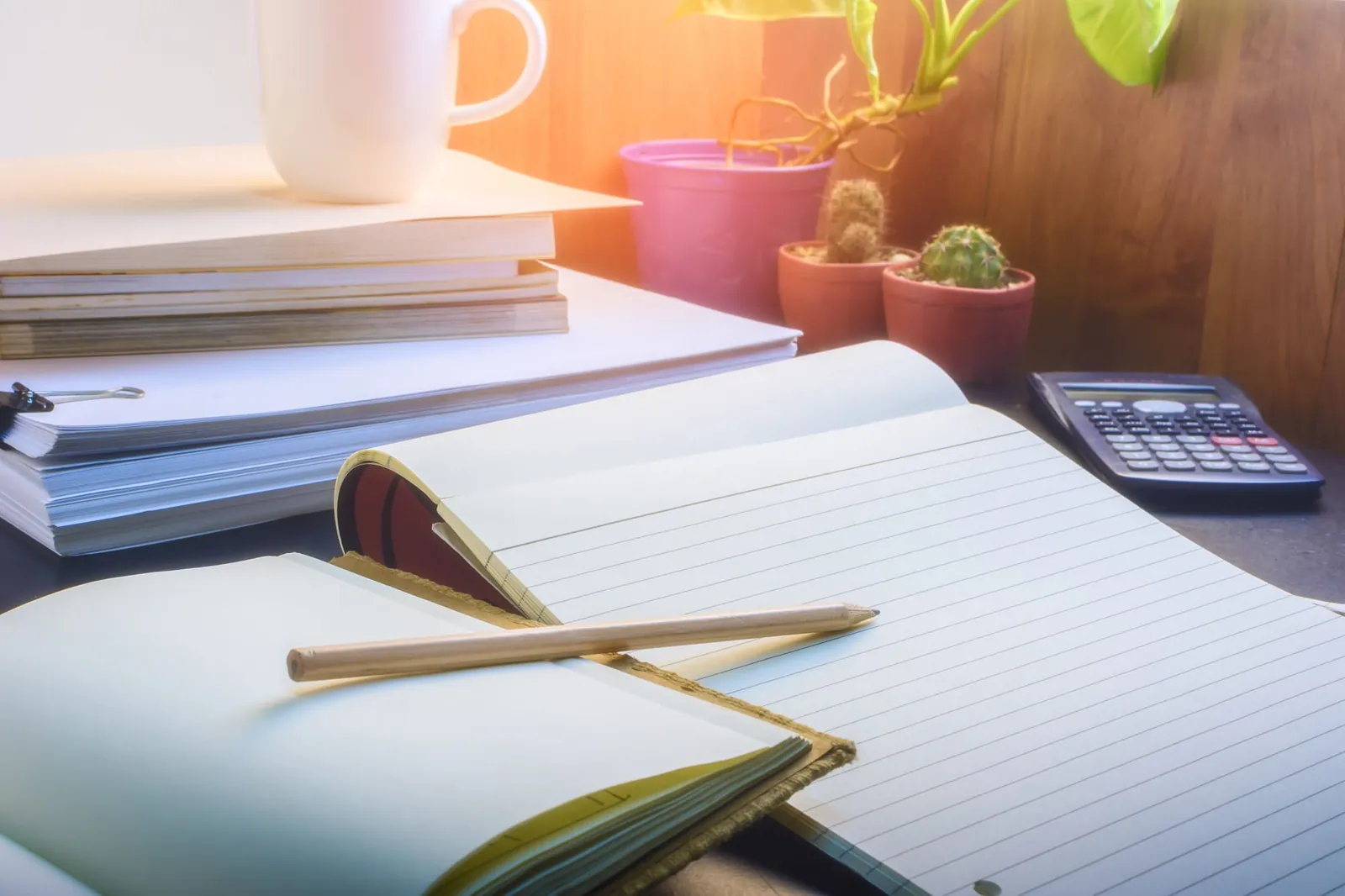 Notebooks, pencil and calculator on a desk