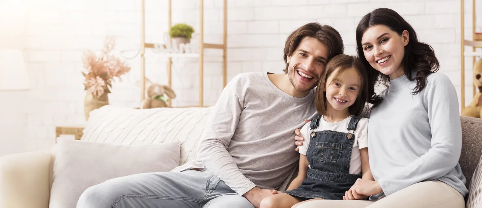 Family smiling together on a sofa